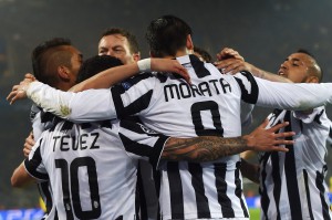 Juventus' Spanish forward Alvaro Morata celebrates scoring with teammates during the Round of 16, second-leg UEFA Champions League football match Borussia Dortmund vs Juventus in Dortmund, western Germany on March 18, 2015.   AFP PHOTO / PATRIK STOLLARZ        (Photo credit should read PATRIK STOLLARZ/AFP/Getty Images)