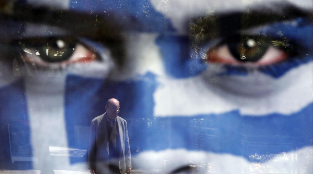 LaPresse05-05-2012PoliticaGrecia, domani si svolgeranno le elezioni politicheA pedestrian is reflected on an election poster of Democratic Alliance party at a bus stop in Athens, Saturday May 5 2012. Greeks head to the polls Sunday in their most critical and uncertain  election in decades, with voters set to punish the two main parties that are being held responsible for the country's dire economic straits.