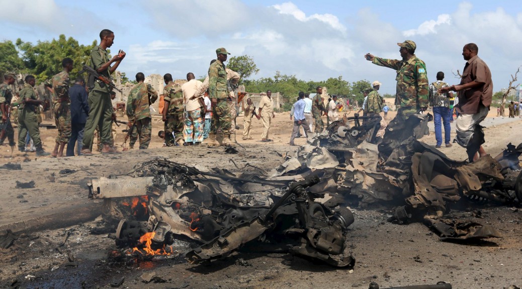 Somali government forces assess the scene of a car bomb attack in Hodan district in the capital Mogadishu June 24, 2015. A car bomb targeting a convoy of military instructors from the United Arab Emirates exploded in the Somali capital of Mogadishu on Wednesday, killing at least three Somalis but injuring no UAE citizens, security officials said. REUTERS/Feisal Omar