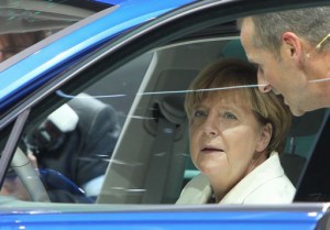 German Chancellor Angela Merkel sits on the driver's seat of a Tiguan GTE Plugin Hybrid car during her visit of the booth of German carmaker Volkswagen on the opening day of the Frankfurt Motor Show IAA in Frankfurt, western Germany, on September 17, 2015. AFP PHOTO / DANIEL ROLAND