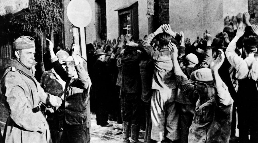 Jews_rounded_up_in_Warsaw_cph.3c32739